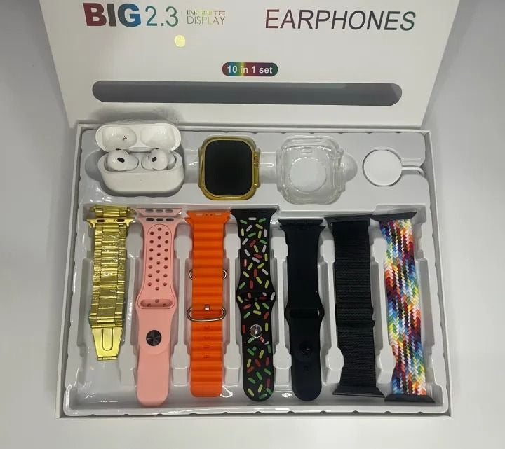 Collection of smartwatch bands and accessories in a box on a gray surface.